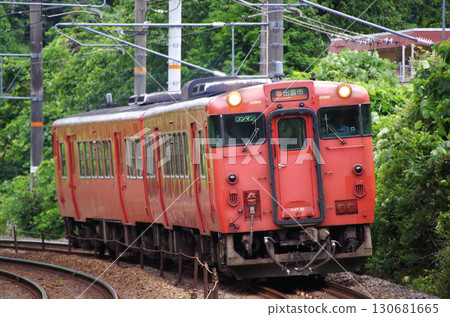 兩輛朱紅色（原日本國家鐵路顏色）的 Kiha 40 系列 Kiha 47 柴油車在山陰本線的彎道中穿梭。 130681665