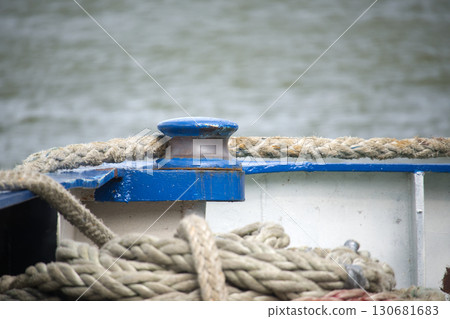 Close-Up of Boat Rope and Cleat with Blurred Water Background 130681683