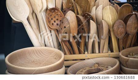 Collection of handcrafted wooden spoons and bowls showcases rustic charm and artisanal craftsmanship 130681688