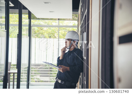 Man construction engineer writing note wear blue shirt safety white hard hat at construction site. Industry labour male worker. Architecture man drawing engineer civil constrcution real estate Man construction engineer writing note wear blue shirt safety white hard hat at construction site. Industry labour male worker. Architecture man drawing engineer civil constrcution real estate 130681740