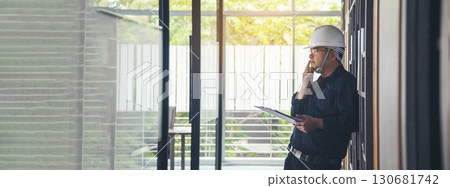 Man construction engineer writing note wear blue shirt safety white hard hat at construction site. Industry labour male worker. Architecture man drawing engineer civil constrcution real estate Man construction engineer writing note wear blue shirt safety white hard hat at construction site. Industry labour male worker. Architecture man drawing engineer civil constrcution real estate 130681742