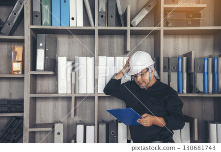 Man construction engineer writing note wear blue shirt safety white hard hat at construction site. Industry labour male worker. Architecture man drawing engineer civil constrcution real estate Man construction engineer writing note wear blue shirt safety white hard hat at construction site. Industry labour male worker. Architecture man drawing engineer civil constrcution real estate 130681743