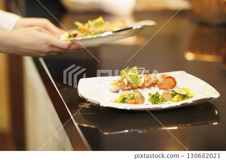 French chef, close-up of hands serving food, work scene French chef, close-up of hands serving food, work scene 130682021