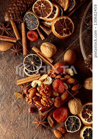 Dried fruits and nuts on a brown vintage background. 130682459