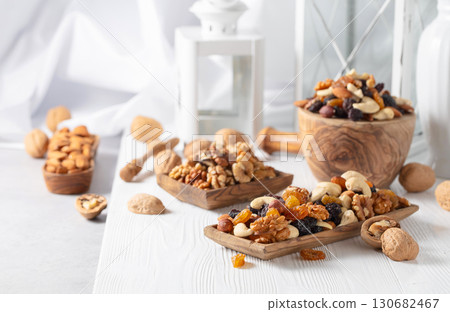 Mix of nuts and raisins on a white table. Mix of nuts and raisins on a white table. 130682467
