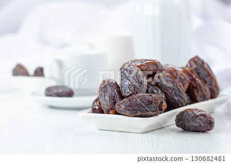 Dried medjool dates on a white table. 130682481