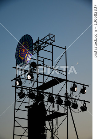 A windmill tower floating in the blue sky at dusk 130682837