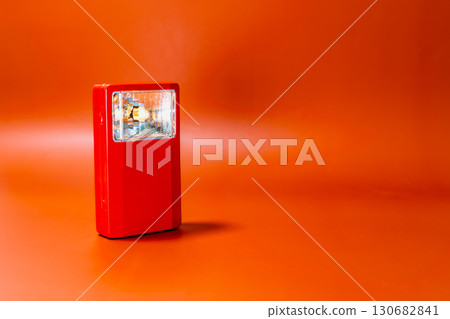 Antique red hand lantern on an orange background. 130682841