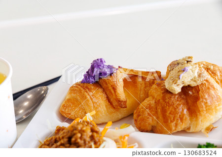 Breakfast buffet. Okinawa's specialty bitter melon chanpuru, carrot stir-fry, etc. Croissants are topped with Okinawa's specialty purple sweet potato and brown sugar. 130683524