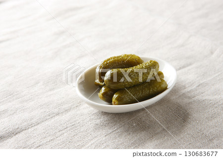 Pickled cucumbers in a white bowl 130683677