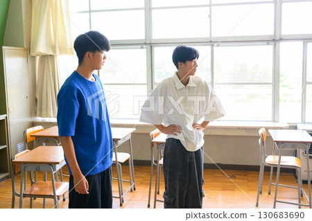 Male students practicing dance in a school classroom. Image of youth and school life. Male students practicing dance in a school classroom. Image of youth and school life. 130683690