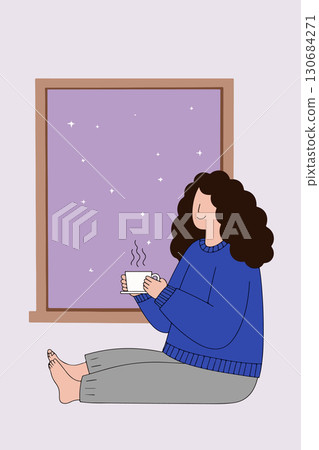 Woman enjoying coffee by the window at night 130684271