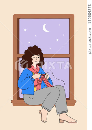 Woman Knitting by the Window at Night 130684278