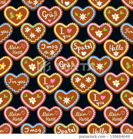 Seamless pattern of Oktoberfest gingerbread heart cookies with colorful icing and German love messages on dark background 130684649