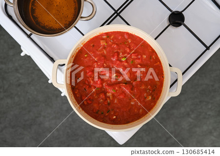 Cooking tomato and bread soup on a stove 130685414