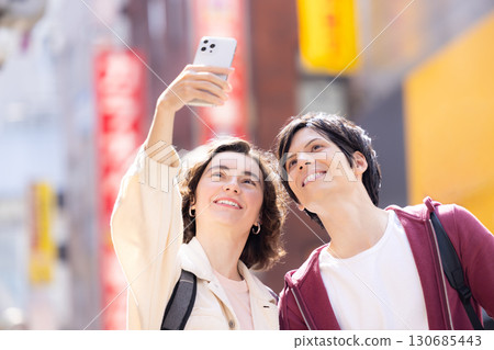 Inbound foreign couple taking a smartphone selfie Inbound foreign couple taking a smartphone selfie 130685443