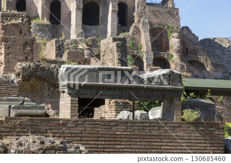 Rome, Italy - August 17, 2019: Fragment of a wall of an ancient Roman structure on the territory of the Roman Forum Rome, Italy - August 17, 2019: Fragment of a wall of an ancient Roman structure on the territory of the Roman Forum 130685460