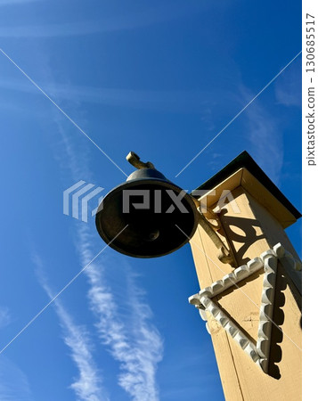 A bell against a bright blue sky. High quality photo 130685517