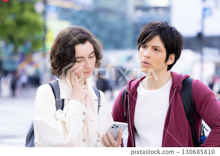 Inbound: Foreigners strolling around the streets of Tokyo while looking at their smartphones Inbound: Foreigners strolling around the streets of Tokyo while looking at their smartphones 130685810