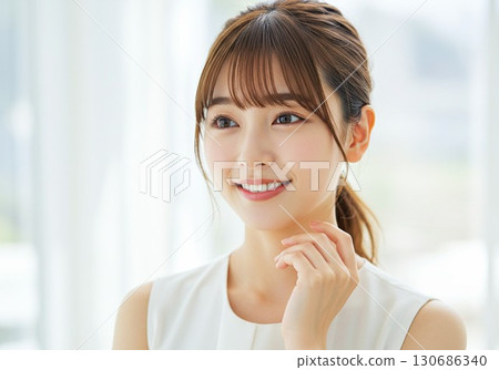 Portrait of a young woman looking up with a smile 130686340
