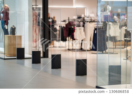 Radio-frequency security gates with integrated metal detector at a clothing store entrance 130686858