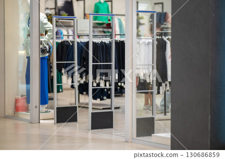 Radio-frequency security gates with integrated metal detector at a clothing store entrance 130686859