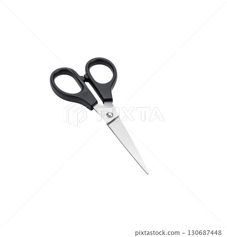 A sharp, stainless steel pair of scissors with black handles is isolated on a white background 130687448
