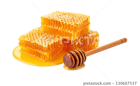Close-up of golden honey in glass jar and natural honeycomb isolated on white background. 130687537