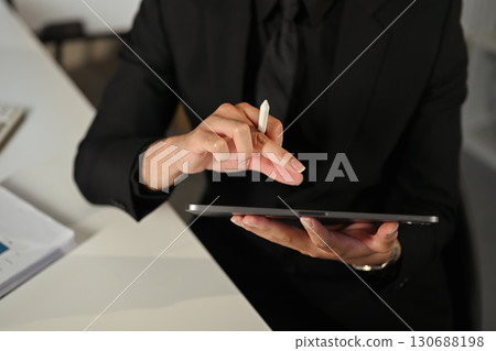 Corporate executive working with digital tablet and stylus for business tasks 130688198