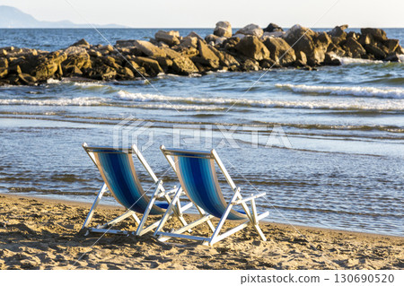 Two beach chairs on the beach on the Tyrrhenian Sea 130690520