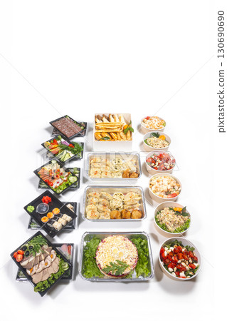 Assorted appetizers, salads, dumplings, and sushi on white background. 130690690
