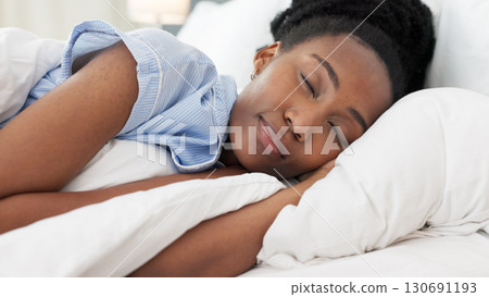 Sleep, relax and black woman in bed, pillow and blanket for dreaming, sleeping and comfortable at home. Morning, bedroom and closeup of tired person with eyes closed for resting, peace and cozy 130691193