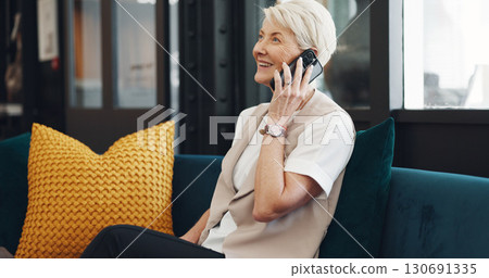 Business, phone call and mature woman with client communication, contact or b2b social networking. Person, talking and happy entrepreneur on sofa in modern office, workplace and speaking on cellphone 130691335