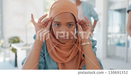 Business, face and muslim woman in office with scarf or hijab, confidence and ambitious mindset. Hands, touch and young islamic female manager moving head wrap in inclusive coworking workspace Business, face and muslim woman in office with scarf or hijab, confidence and ambitious mindset. Hands, touch and young islamic female manager moving head wrap in inclusive coworking workspace 130691352