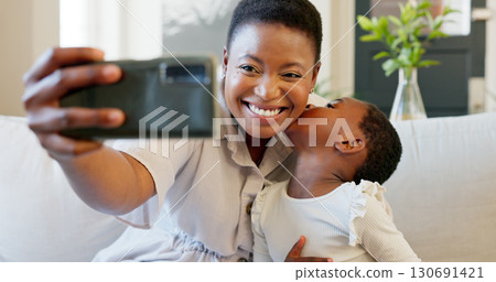 Kiss, selfie and mother with girl child on sofa at home with love, hug and happy bond or memory. Smartphone, smile and black family in living room for parent influencer, podcast or profile picture Kiss, selfie and mother with girl child on sofa at home with love, hug and happy bond or memory. Smartphone, smile and black family in living room for parent influencer, podcast or profile picture 130691421