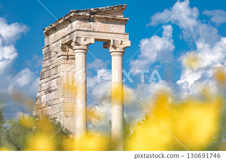 Sanctuary of Apollo Hylates showing columns on sunny day with yellow flowers and blue sky. Cyprus Sanctuary of Apollo Hylates showing columns on sunny day with yellow flowers and blue sky. Cyprus 130691746