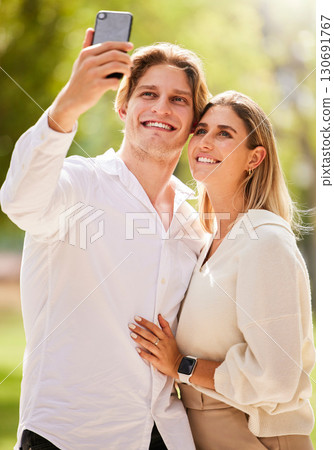 Couple, selfie and happiness outdoor for love, care and smile together in nature garden for social media. Happy man, young woman and take photograph in park for holiday, date and relax in summer Couple, selfie and happiness outdoor for love, care and smile together in nature garden for social media. Happy man, young woman and take photograph in park for holiday, date and relax in summer 130691767