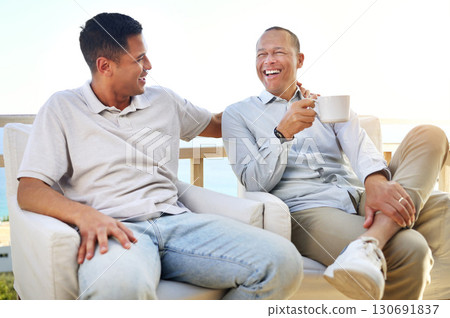 Laughing, talking and father and son with coffee, bonding and speaking during visit. Family, happy and dad with an adult man for communication about a funny story, conversation and tea on the balcony Laughing, talking and father and son with coffee, bonding and speaking during visit. Family, happy and dad with an adult man for communication about a funny story, conversation and tea on the balcony 130691837