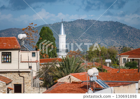 White minaret of Hamidiye Mosque towering over Pano Lefkara village in Cyprus. Larnaca District White minaret of Hamidiye Mosque towering over Pano Lefkara village in Cyprus. Larnaca District 130691898