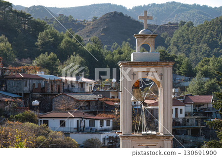 Church bell tower overlooking Platanistasa village in Cyprus with Troodos mountains in background. Nicosia District 130691900