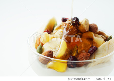 Greek yogurt with lots of ingredients and honey Greek yogurt with lots of ingredients and honey 130691935