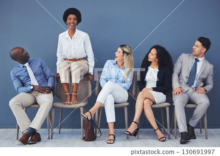 Business people, hiring and waiting room of woman standing out against wall for interview, meeting or opportunity. Group of diverse interns looking at African American female candidate in recruitment Business people, hiring and waiting room of woman standing out against wall for interview, meeting or opportunity. Group of diverse interns looking at African American female candidate in recruitment 130691997