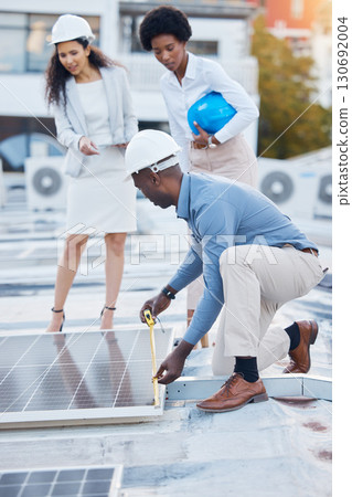Black man, roof and solar panel installation team of construction worker technician outdoor. Businessman, renewable energy and industrial eco friendly panels of maintenance employee and handyman 130692004