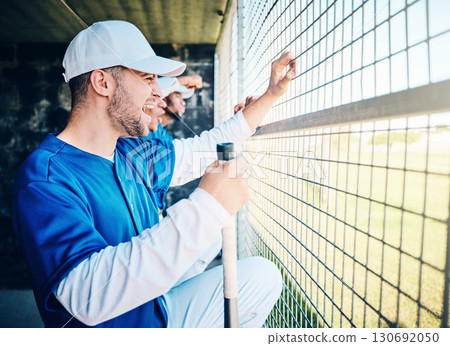 Baseball, dugout and excited man watching game holding bat, competition and winning sport. Fitness, health and serious sports player waiting for turn to play in fun practice match at stadium or field 130692050
