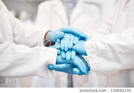 Doctor, team and hands together with gloves in healthcare, partnership or trust for collaboration, unity or support at lab. Group of medical experts piling hand in teamwork for motivation or safety 130692276