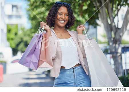 Shopping bag, portrait and Indian woman happy on city street from discount, promotion and sale. Retail store sales, happiness and young customer feeling excited from shop choice at a boutique Shopping bag, portrait and Indian woman happy on city street from discount, promotion and sale. Retail store sales, happiness and young customer feeling excited from shop choice at a boutique 130692316