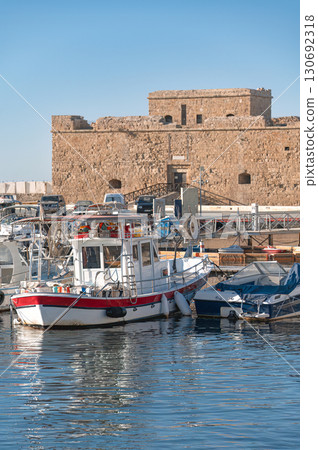 Fishing boat moored near Paphos castle in Cyprus harbour on sunny day 130692318