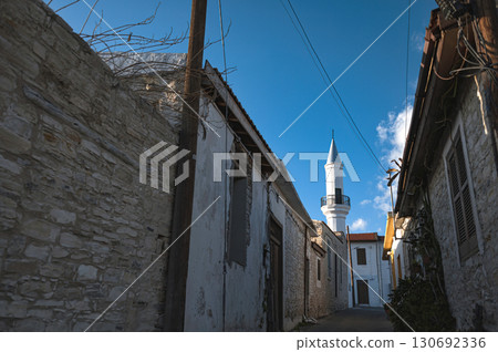 Minaret tower of Hamidiye Mosque rising above traditional stone houses in pano lefkara, cyprus Minaret tower of Hamidiye Mosque rising above traditional stone houses in pano lefkara, cyprus 130692336