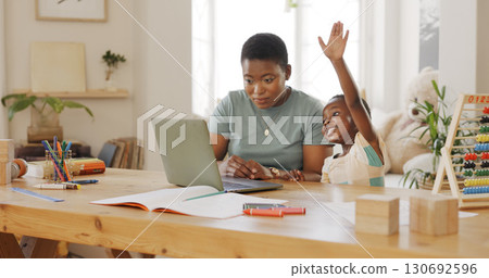 Child raise hand for elearning on laptop for knowledge video call for development at home. Technology, online class and black woman helping boy kid with homework on computer in dining room at a house Child raise hand for elearning on laptop for knowledge video call for development at home. Technology, online class and black woman helping boy kid with homework on computer in dining room at a house 130692596