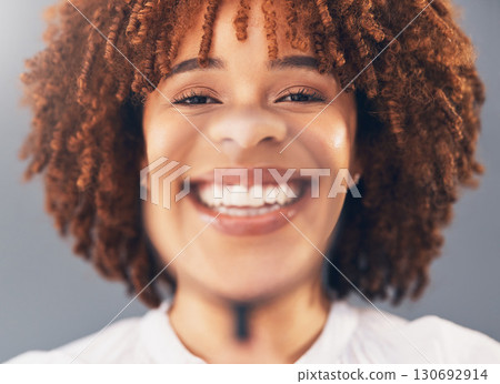 Happy, portrait and woman model with magnifying glass in studio for over her face, mouth and teeth. Dental, healthcare and young African female with a smile in zoom or magnifier by gray background Happy, portrait and woman model with magnifying glass in studio for over her face, mouth and teeth. Dental, healthcare and young African female with a smile in zoom or magnifier by gray background 130692914